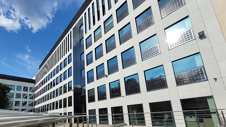 Photo of a modern building. The facade is white.